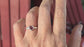 Hand wearing a handcrafted silver ring featuring a dark pink Rubellite Tourmaline stone.