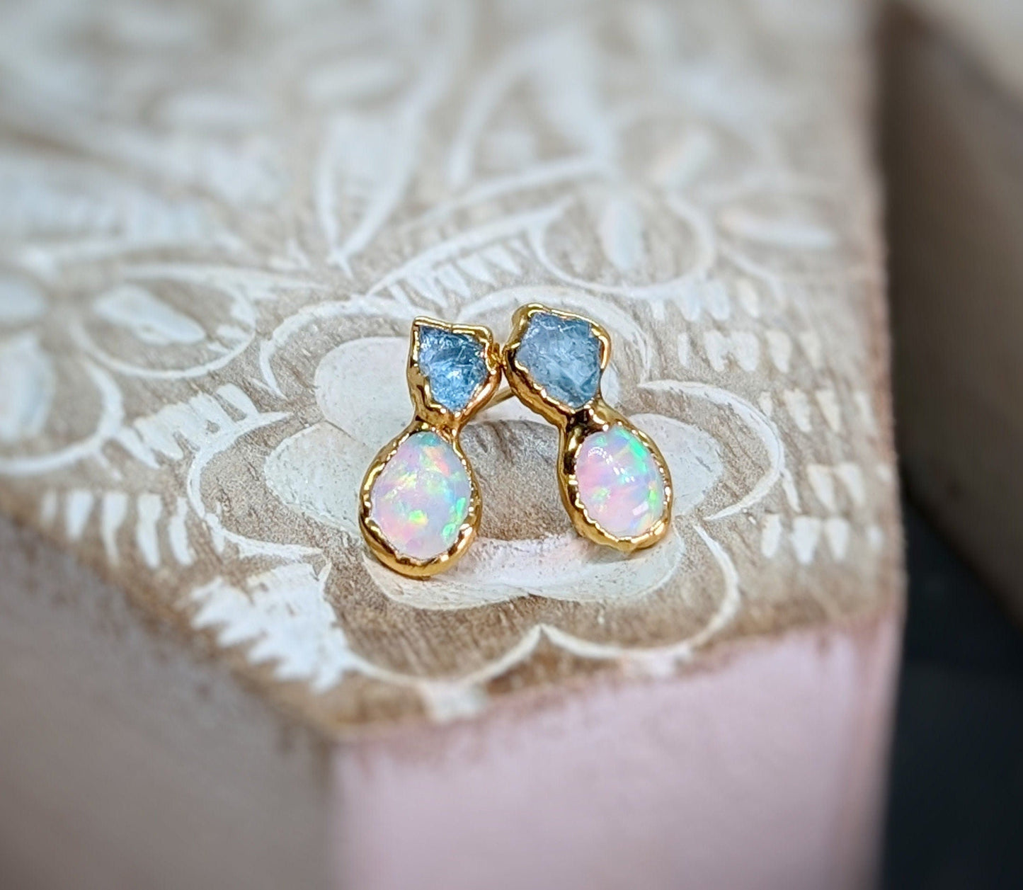 Raw aquamarine and opal stud earrings, handcrafted with gold accents, perfect for elegant or bridal wear.