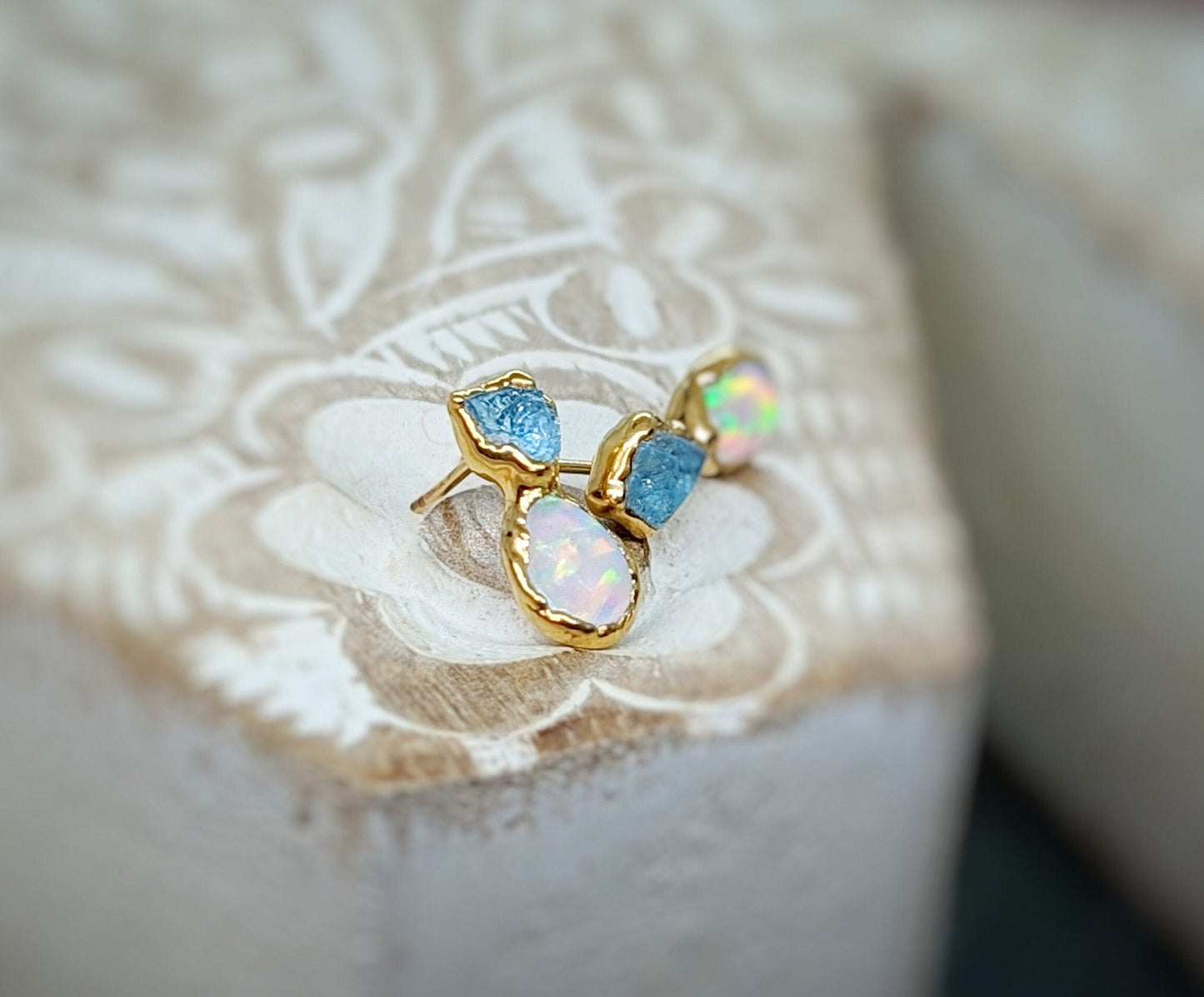 Dainty raw Aquamarine and Opal stud earrings on display, handcrafted with rustic elegance, perfect for gifting.