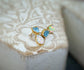 Dainty raw Aquamarine and Opal stud earrings on display, handcrafted with rustic elegance, perfect for gifting.