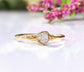 Raw diamond engagement ring on a solid 14k gold band, showcasing rustic elegance and a unique crystal centerpiece.