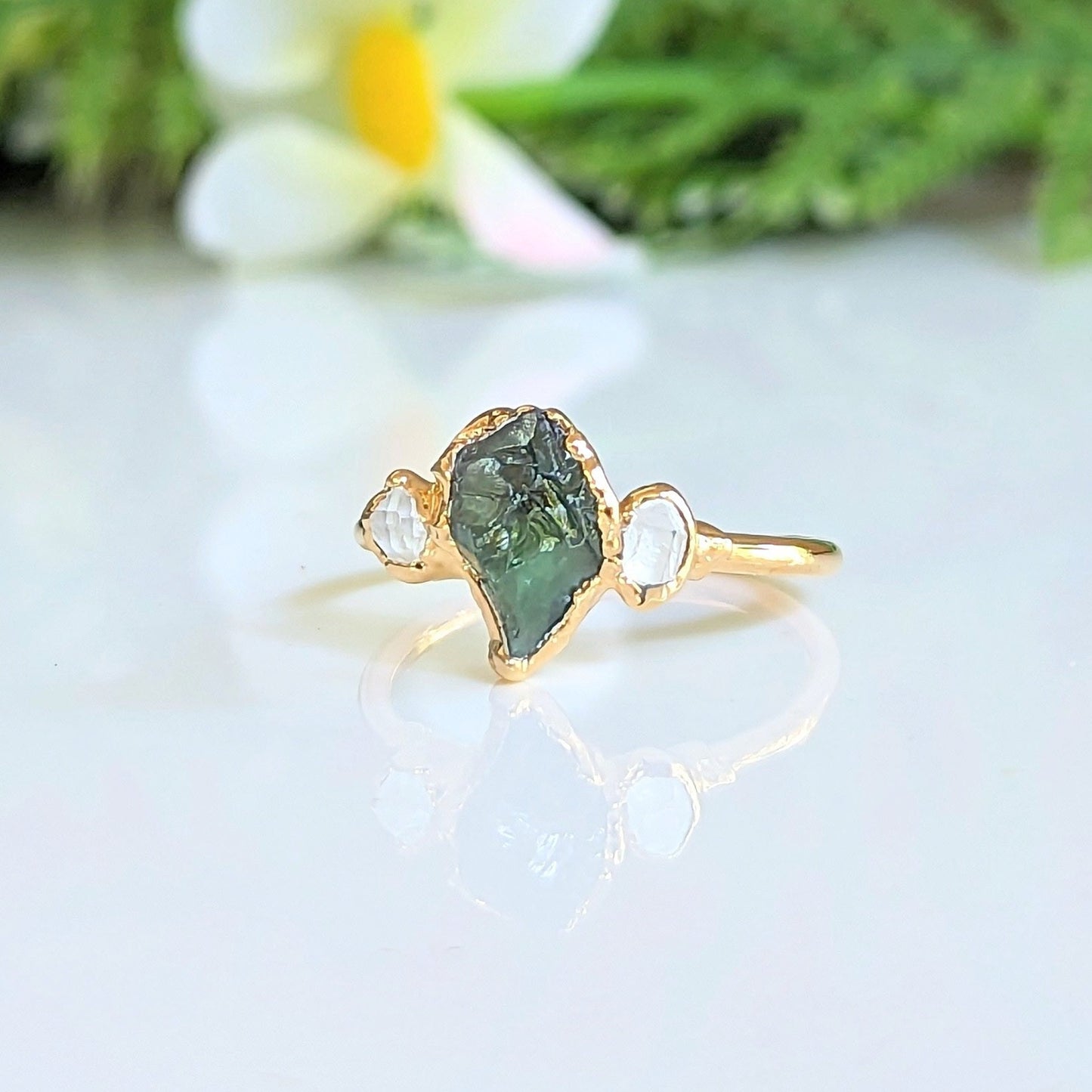Raw green Sapphire engagement ring with Herkimer diamonds set in 14k gold, perfect for unique promises or gifts.