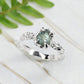 Raw Montana Sapphire engagement ring in solid 14k gold with organic textured band and teal gemstone.