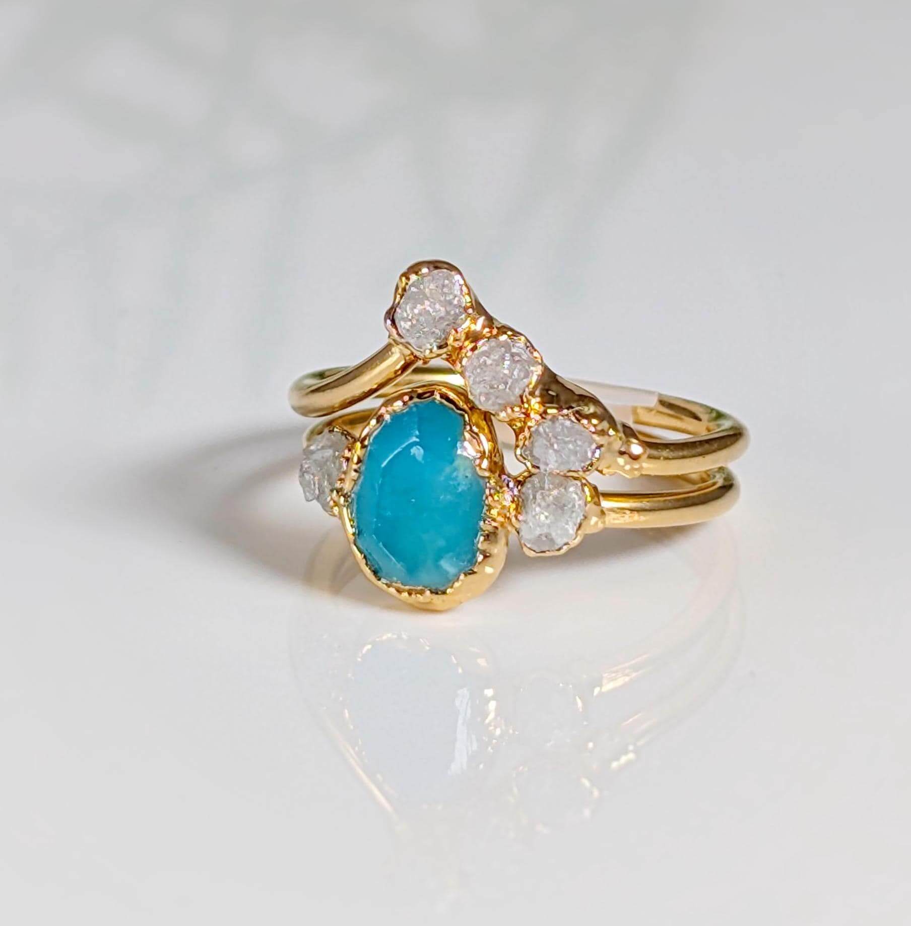 Stunning raw Peruvian Opal engagement ring set with diamond accents, showcasing unique aqua-blue hues and gold band.