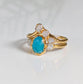 Stunning raw Peruvian Opal engagement ring set with diamond accents, showcasing unique aqua-blue hues and gold band.