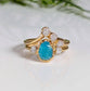 Raw Peruvian Opal and diamond engagement ring set in gold, showcasing a stunning aqua-blue opal and sparkling diamonds.