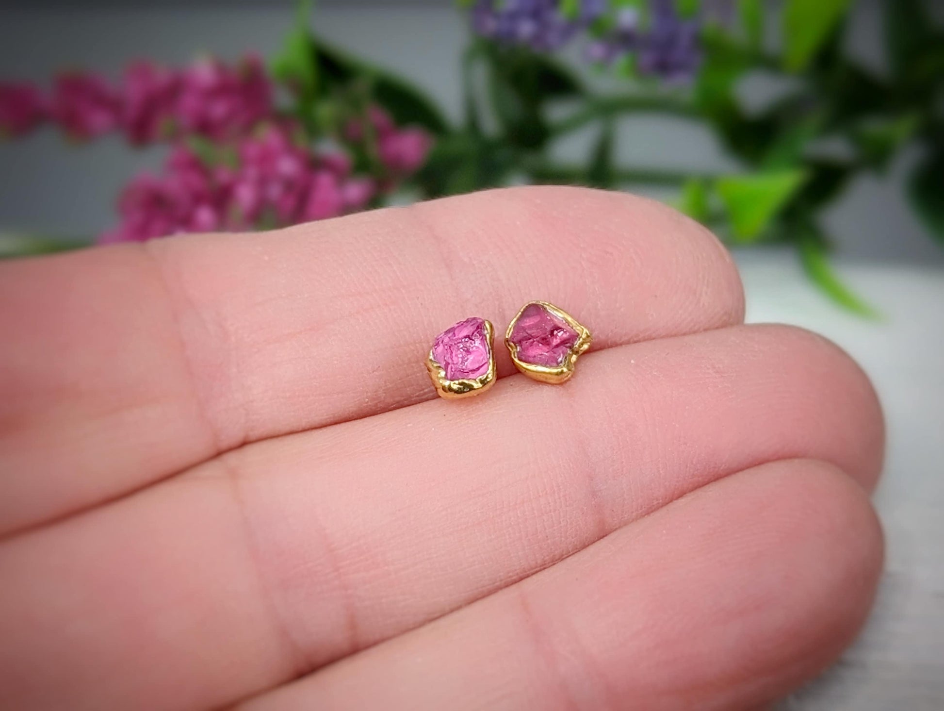 Handcrafted raw pink Spinel stud earrings set in 14k gold, showcasing unique gemstone details.