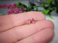Handcrafted raw pink Spinel stud earrings set in 14k gold, showcasing unique gemstone details.