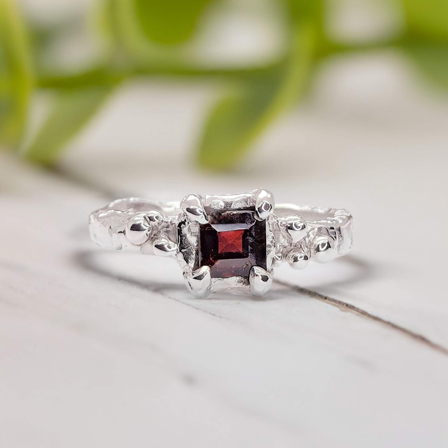 Red Garnet engagement ring in solid sterling silver with organic textured band, handcrafted elegance.