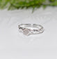 Raw diamond engagement ring in recycled silver with an organic molten texture, showcasing rustic elegance.