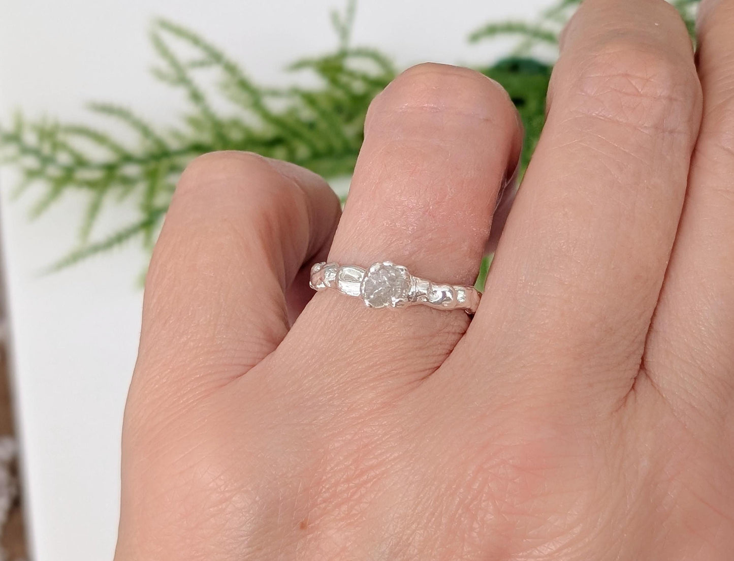 Raw diamond engagement ring in recycled silver, showcasing a rustic, organic design and natural elegance.