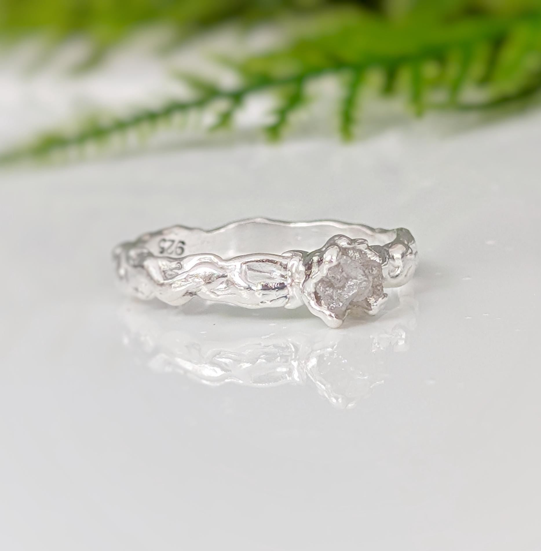 Rustic raw diamond engagement ring set in recycled sterling silver, featuring an organic, molten texture.