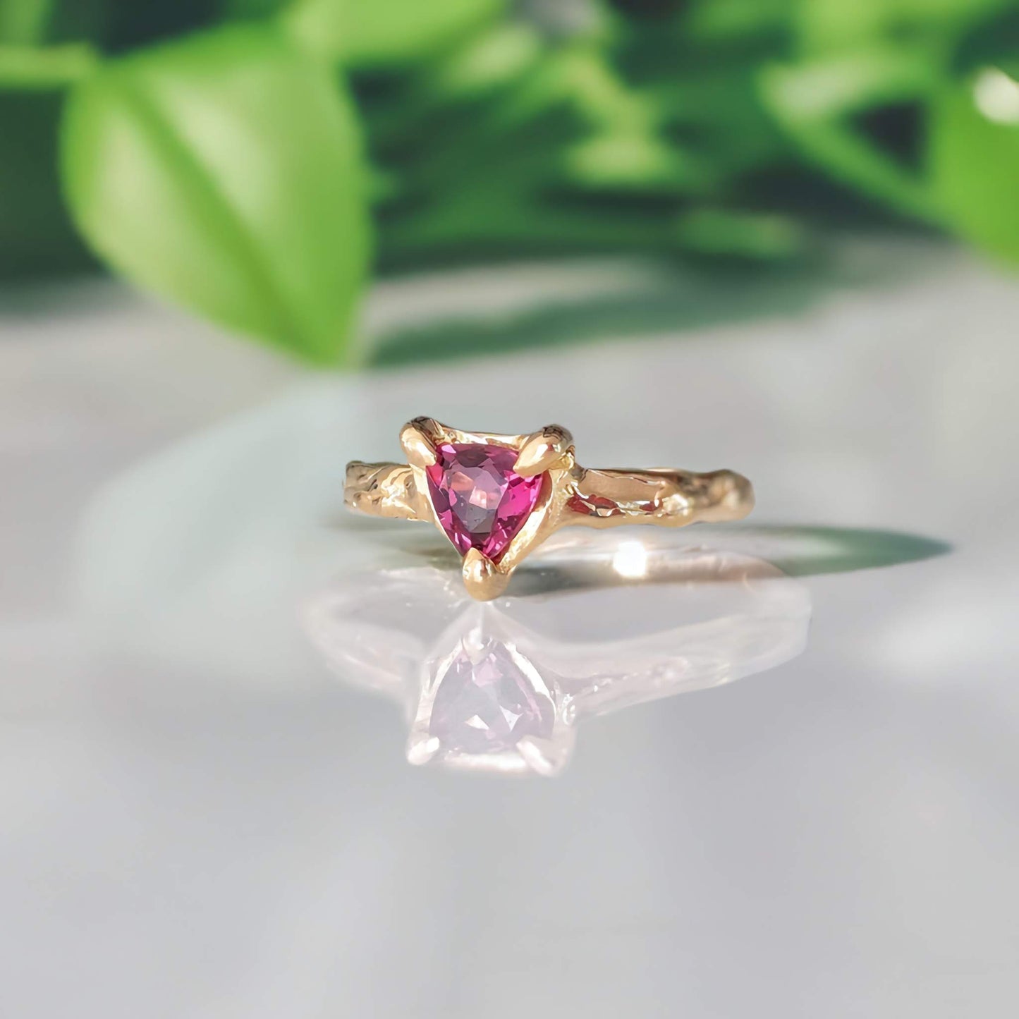 Handcrafted trilliant Rubellite Tourmaline engagement ring in solid 14k gold with textured band.