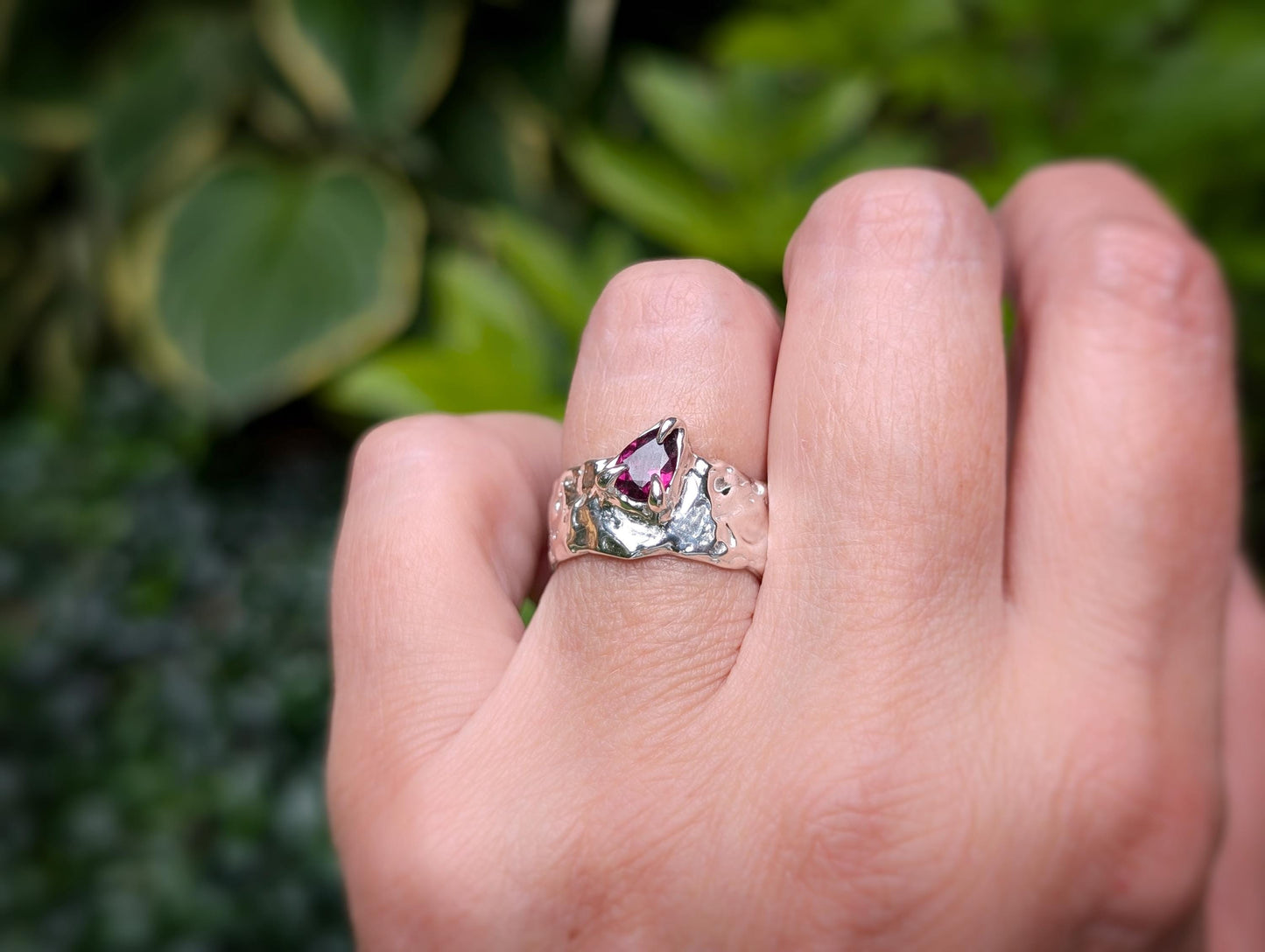 Handcrafted Rubellite Tourmaline ring in solid 14k gold, featuring a textured design and pear-shaped stone.