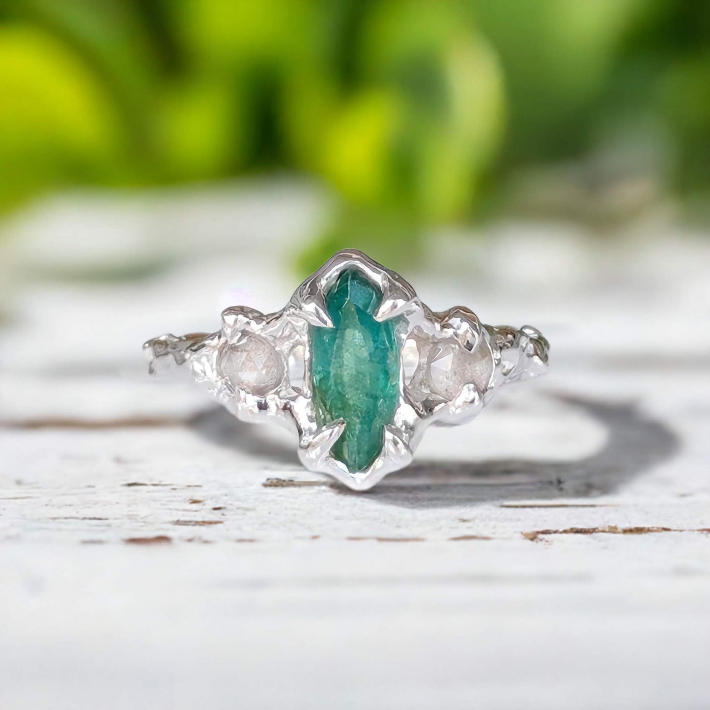 Hand-carved silver Emerald engagement ring with Marquise cut Emerald and Salt & Pepper diamonds.