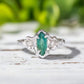Hand-carved silver Emerald engagement ring with Marquise cut Emerald and Salt & Pepper diamonds.