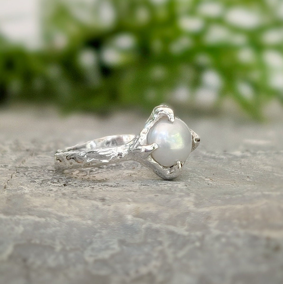 Silver textured ring featuring a creamy-white Freshwater Keshi pearl in a unique organic design.