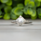Textured sterling silver ring featuring a creamy-white Freshwater Keshi pearl, with a unique organic design.