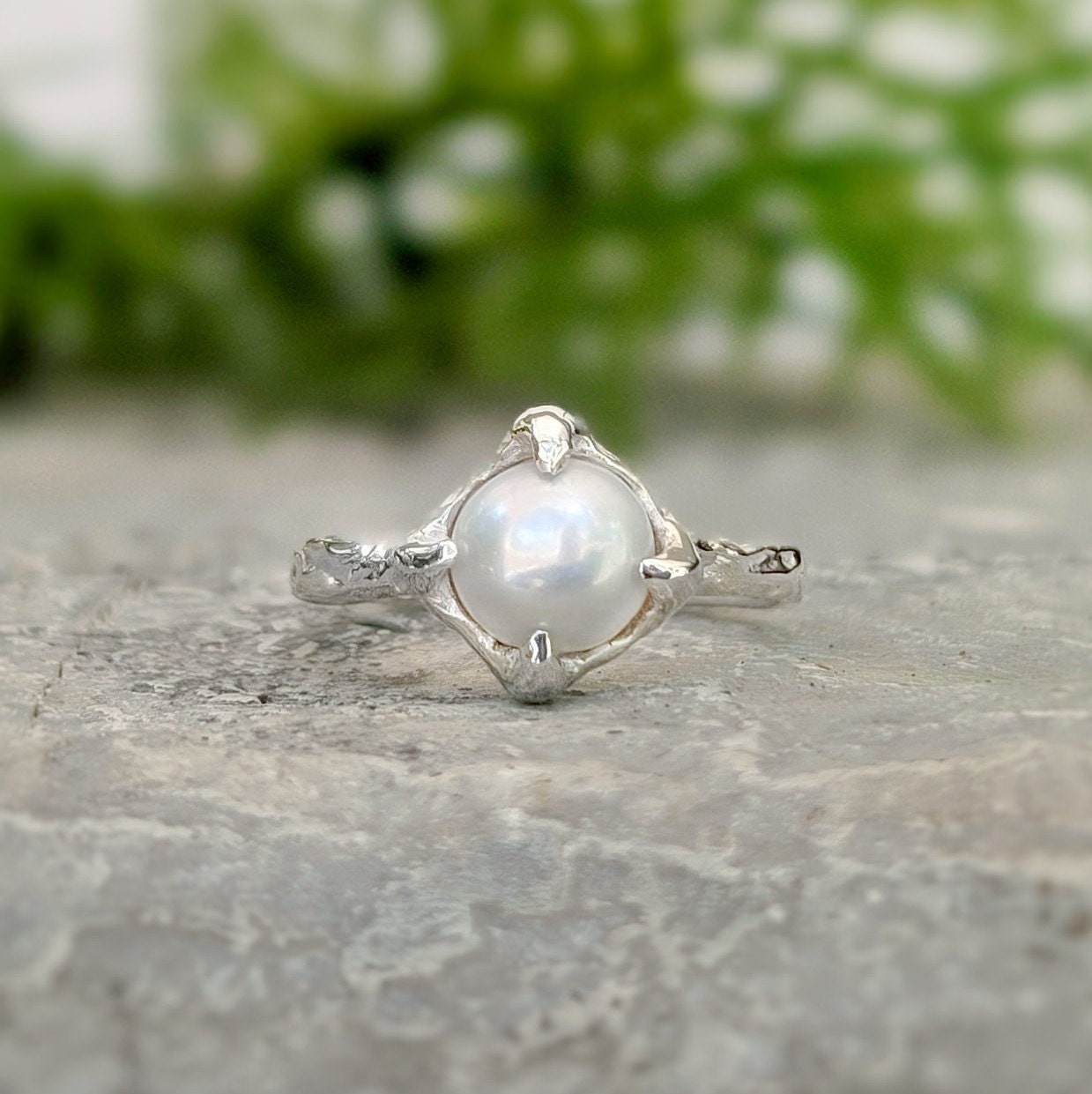 Textured sterling silver ring featuring a creamy-white Freshwater Keshi pearl, perfect for elegant simplicity.