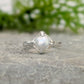 Textured sterling silver ring featuring a creamy-white Freshwater Keshi pearl, perfect for elegant simplicity.