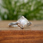 Textured sterling silver ring featuring a creamy-white Freshwater Keshi pearl, elegant and timeless design.