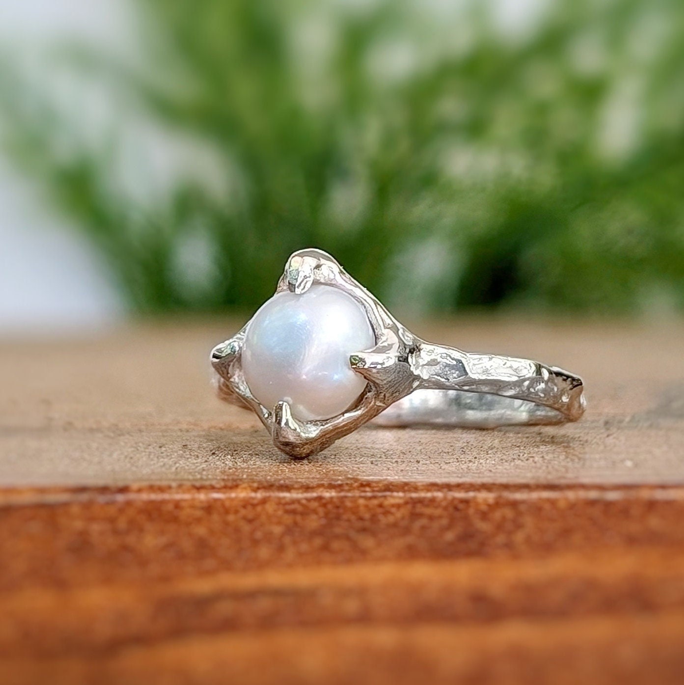 Silver textured ring featuring a creamy-white Freshwater Keshi pearl, perfect for a timeless and elegant style.
