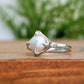 Silver textured ring featuring a creamy-white Freshwater Keshi pearl, perfect for a timeless and elegant style.