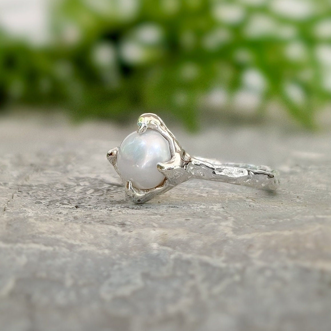Textured sterling silver ring featuring a creamy-white Freshwater Keshi pearl, elegant and unique, perfect for simplicity lovers.