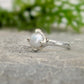 Textured sterling silver ring featuring a creamy-white Freshwater Keshi pearl, elegant and unique, perfect for simplicity lovers.