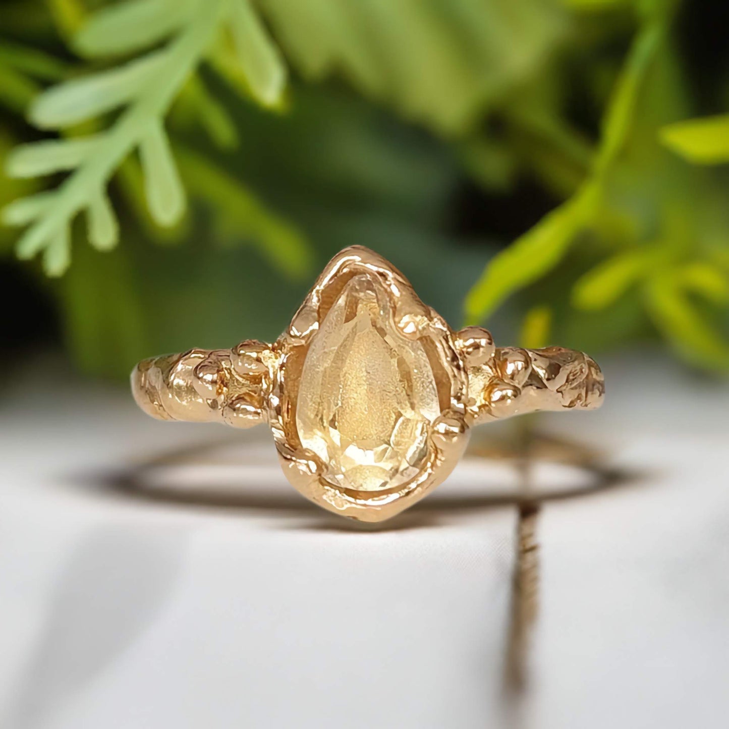 Beautiful pear-shaped citrine ring in solid 14k gold with an organic textured band, perfect for an engagement or anniversary.