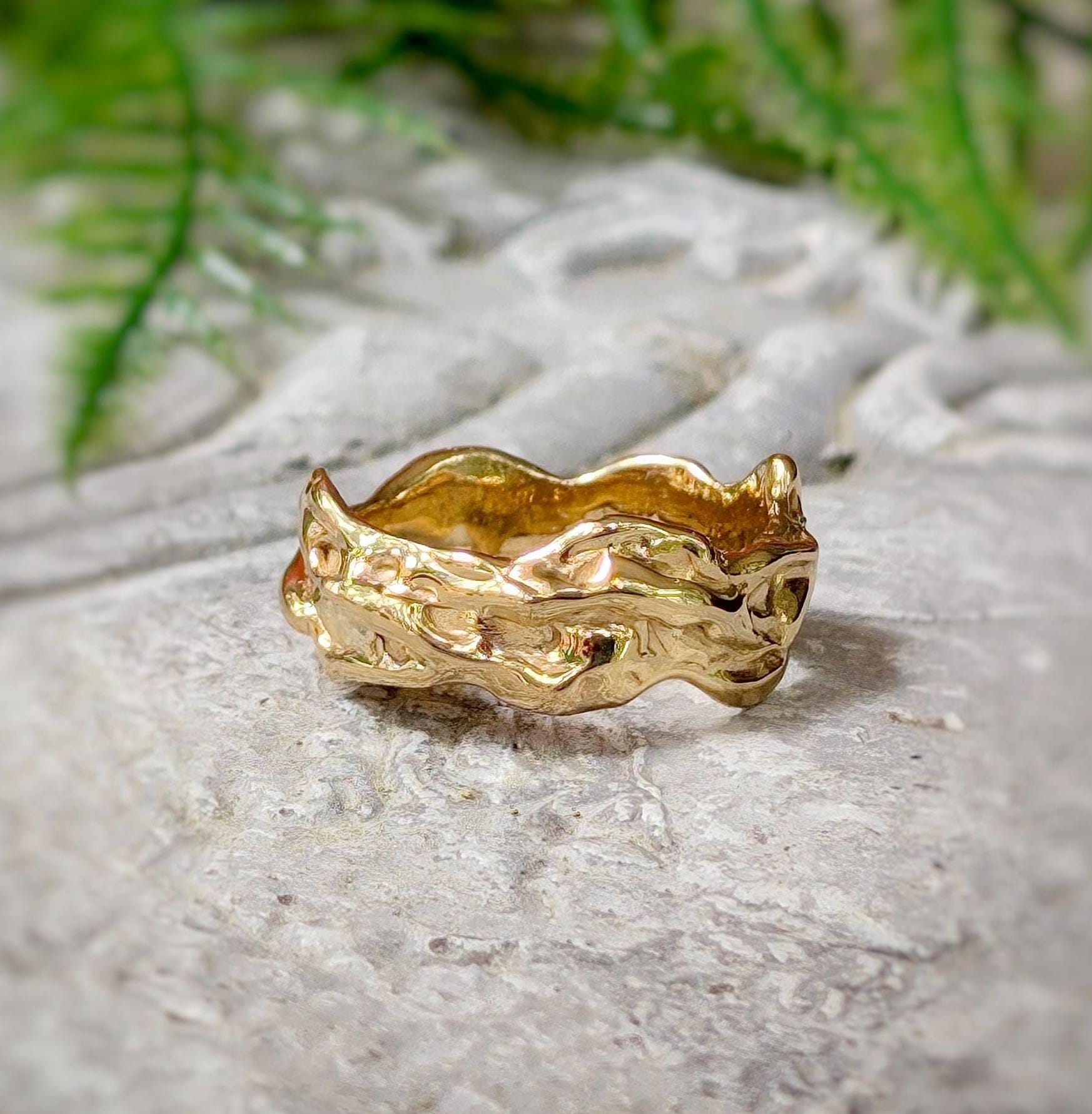 Handcrafted solid 14k gold molten textured wedding band with irregular abstract form, perfect for men or women.
