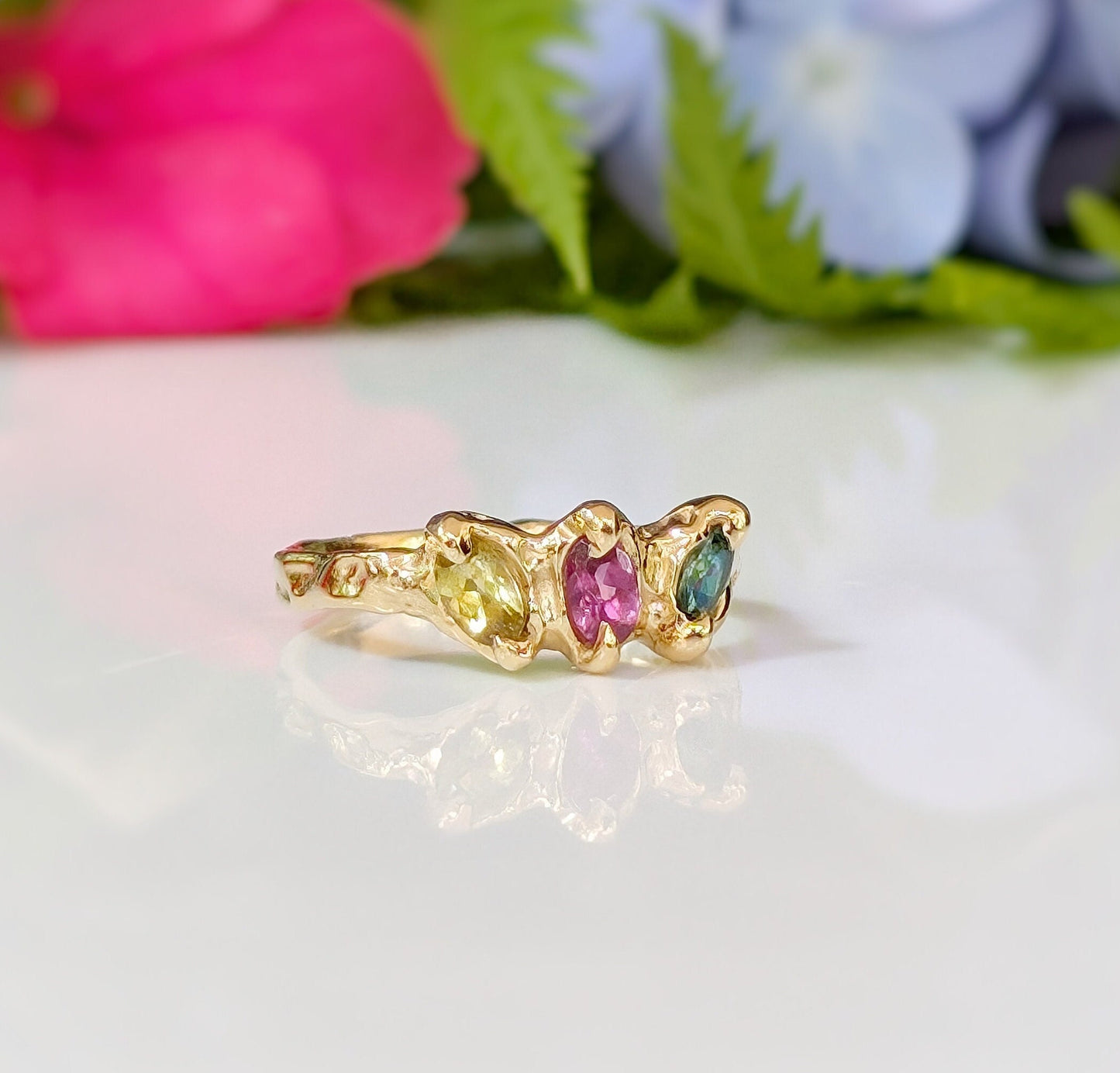Solid gold multi Tourmaline ring featuring three colorful gemstones, ideal as a promise or engagement ring.