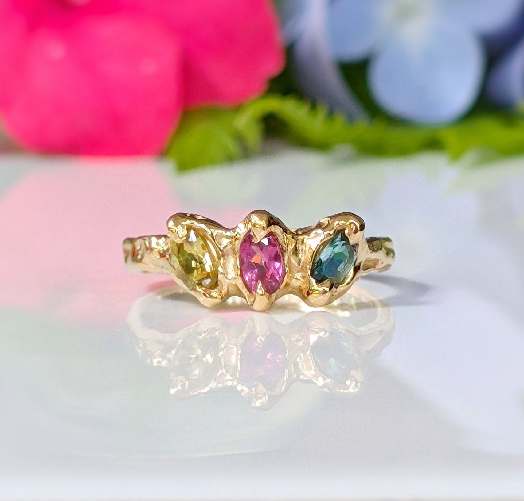 Solid gold multi Tourmaline ring featuring three colorful gemstones, perfect as a unique promise or engagement ring.
