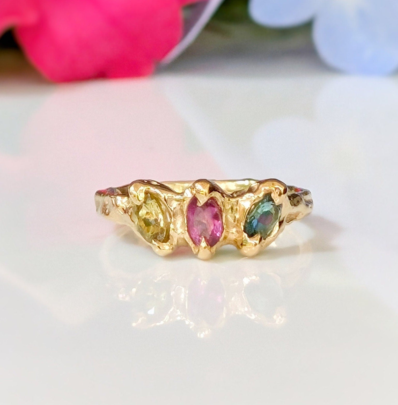 Solid gold multi Tourmaline ring featuring three colorful gemstones in an organic design, perfect for promise or engagement.