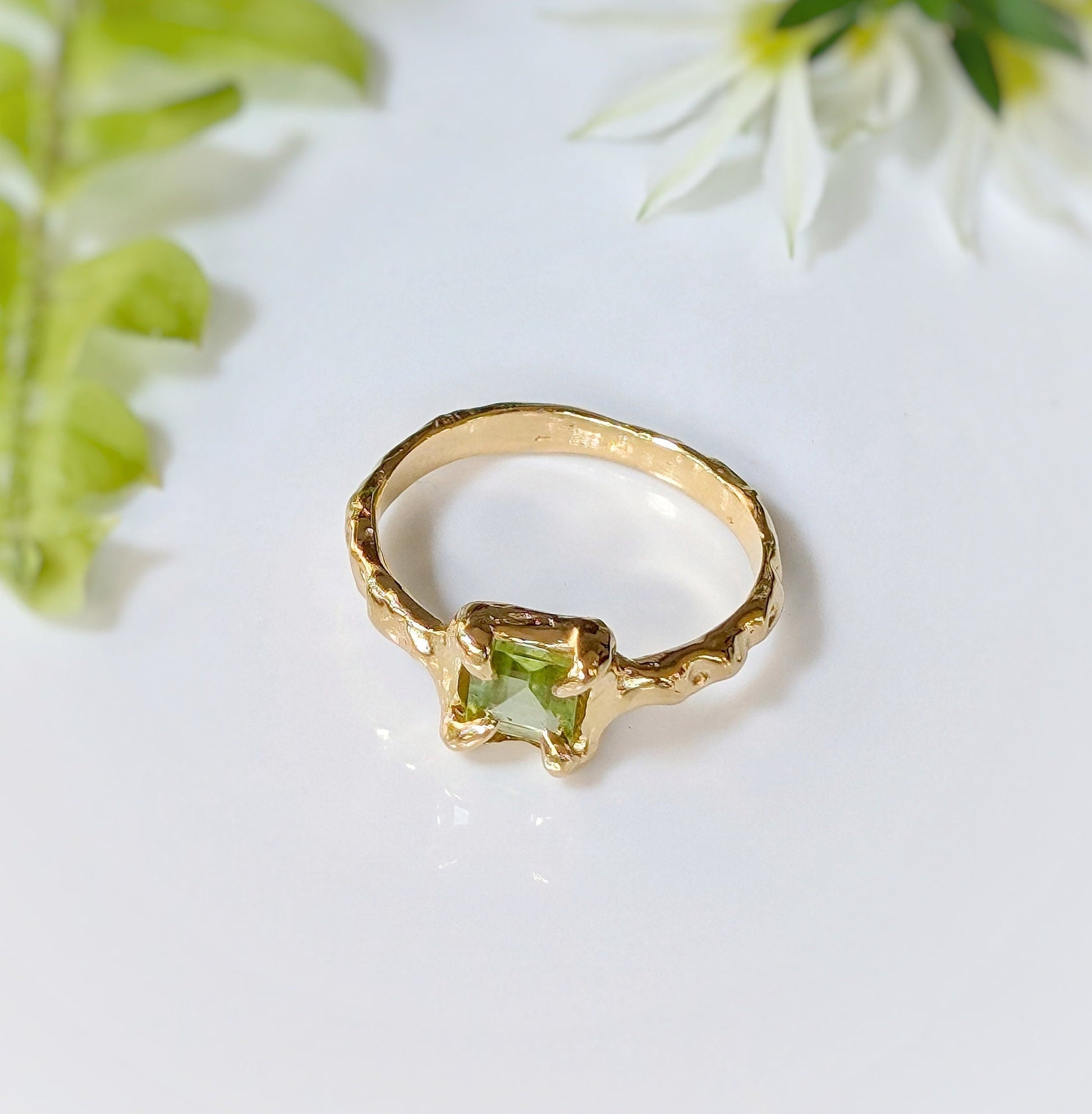 Solid gold Peridot ring featuring organic textured band, showcasing a princess-cut Peridot, ideal for engagement or special occasions.