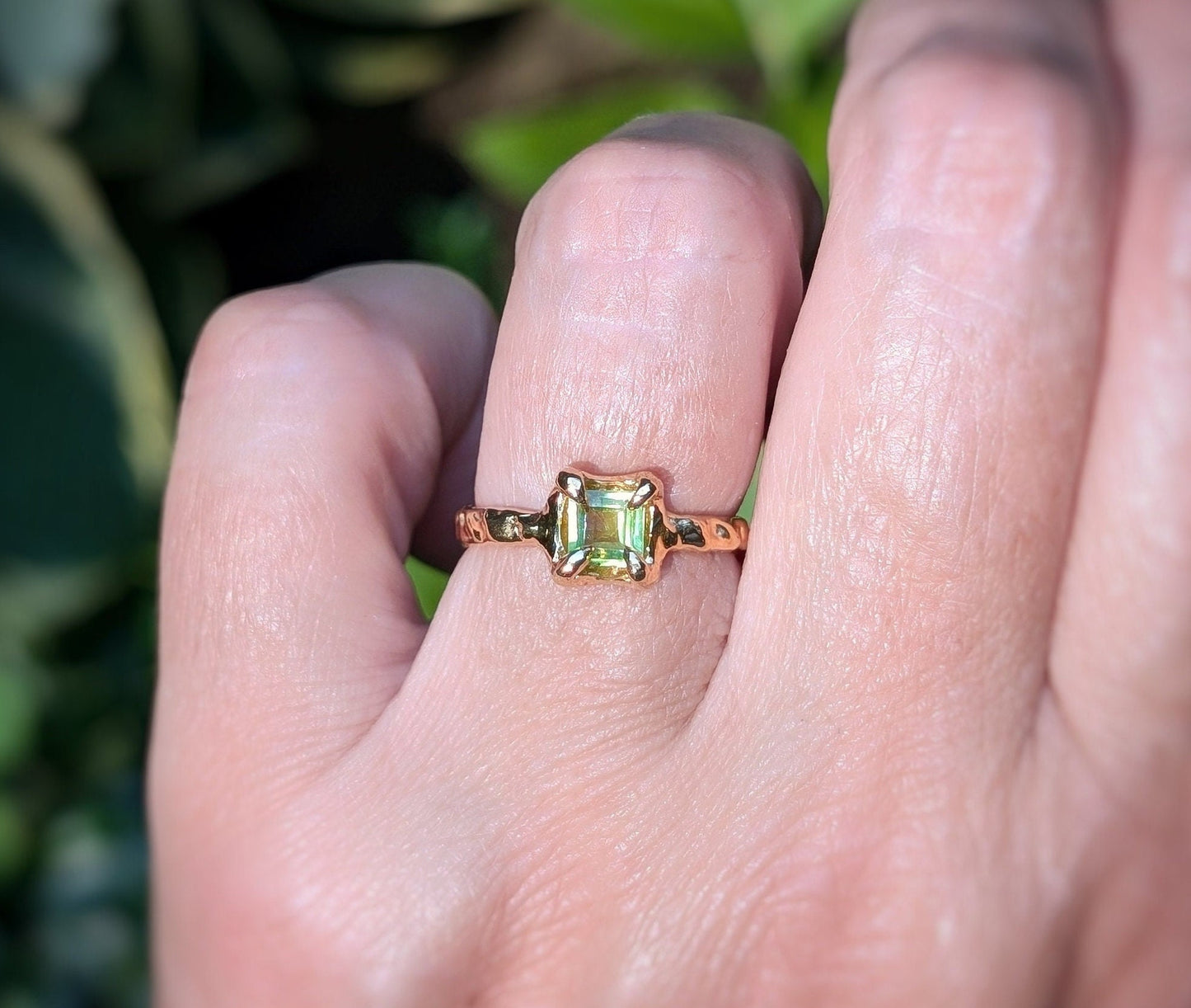 Solid 14k gold ring featuring a princess-cut Peridot, showcasing a unique organic textured band.