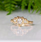 Rustic gold ring featuring a heart-shaped diamond and two side stones, ideal for unique engagement.