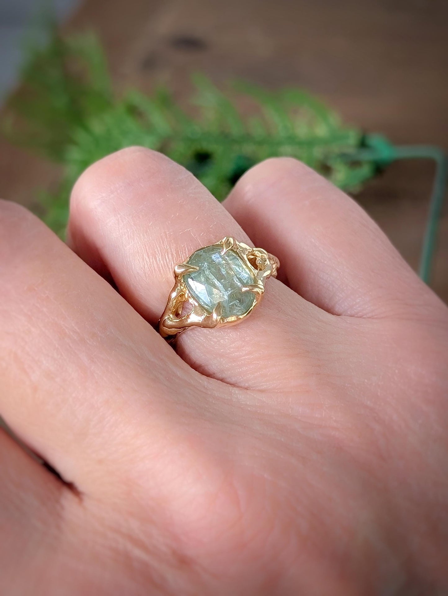Solid 14k Gold textured ring featuring an oval rose cut green Kyanite stone, showcasing artisanal craftsmanship.