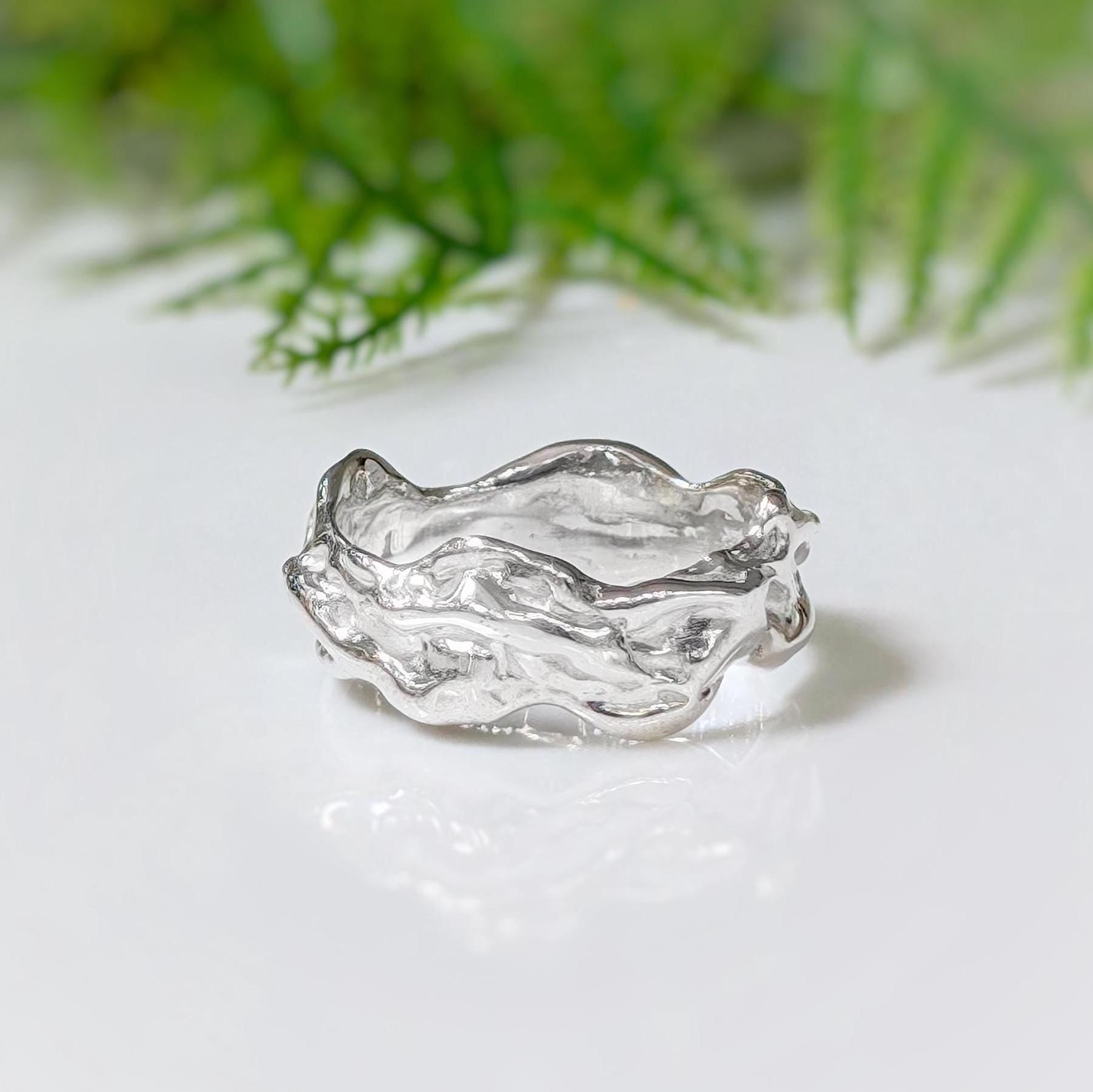 Handcrafted sterling silver molten textured ring, featuring an abstract liquid metal design, perfect for unique weddings.