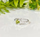 Handcrafted solid silver peridot ring with an organic textured band, featuring a princess-cut peridot gemstone.