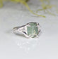 Sterling Silver ring featuring a textured band and a stunning oval-shaped green kyanite stone.