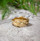 Textured molten gold wedding ring showcasing an irregular, fluid design, handcrafted in Solid 14k Gold.
