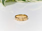 Handcrafted molten gold textured wedding ring with rustic organic design, perfect for celebrating timeless love.