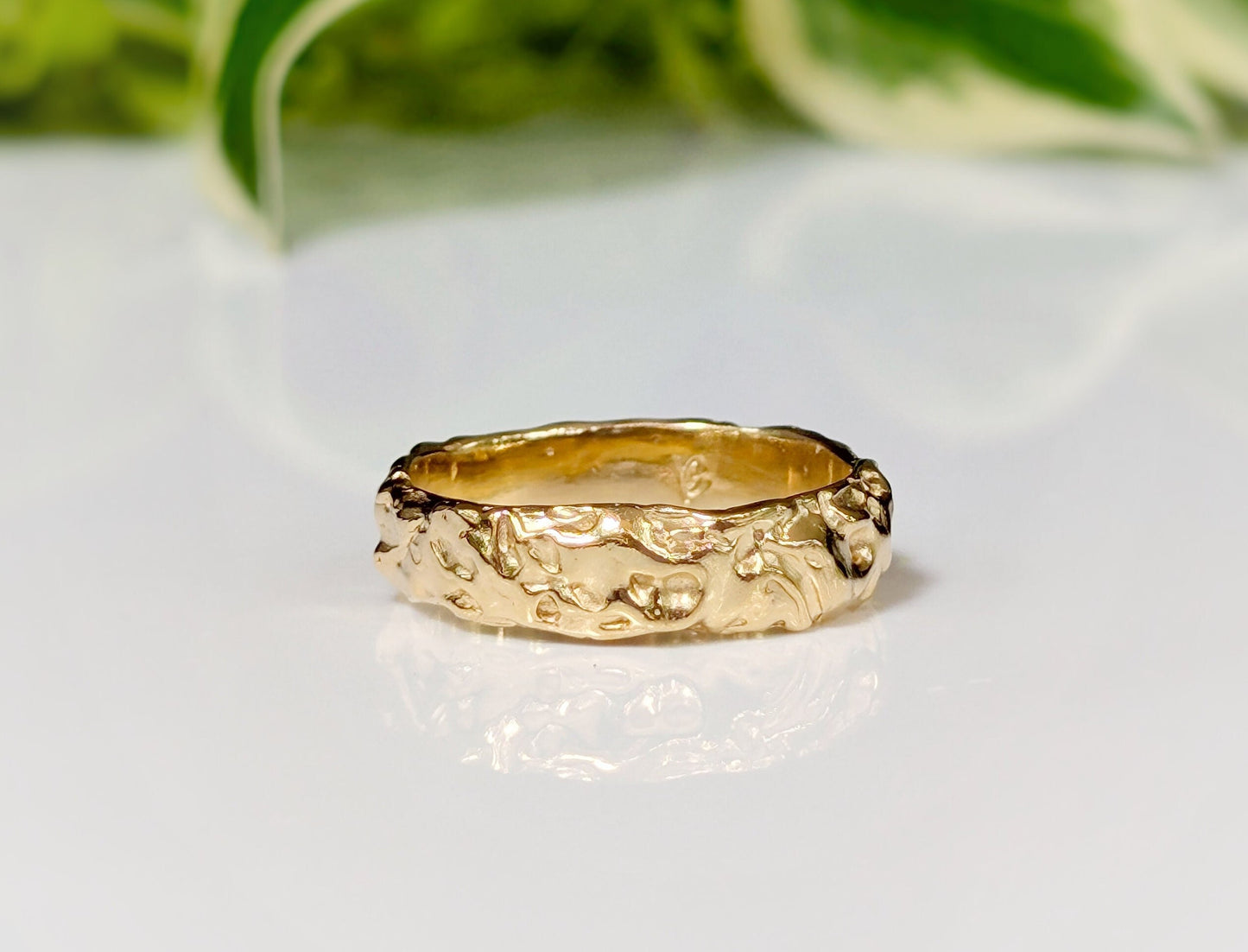 Handcrafted Molten Gold Wedding Ring with rustic textures, showcasing a wide band design inspired by nature's beauty.