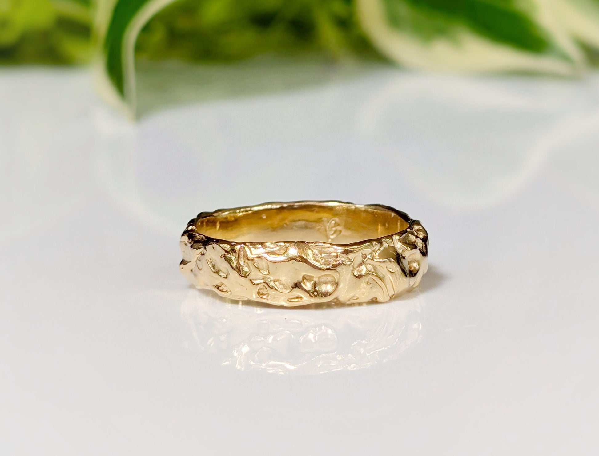 Handcrafted Molten Gold Wedding Ring with rustic textures, showcasing a wide band design inspired by nature's beauty.