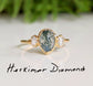 Moss Agate and Herkimer diamond engagement ring on gold band, featuring pear shape Moss Agate and raw Herkimer diamonds.