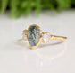 Pear-shaped Moss Agate ring with Herkimer diamonds on a 14k Gold band, showcasing natural beauty and elegance.