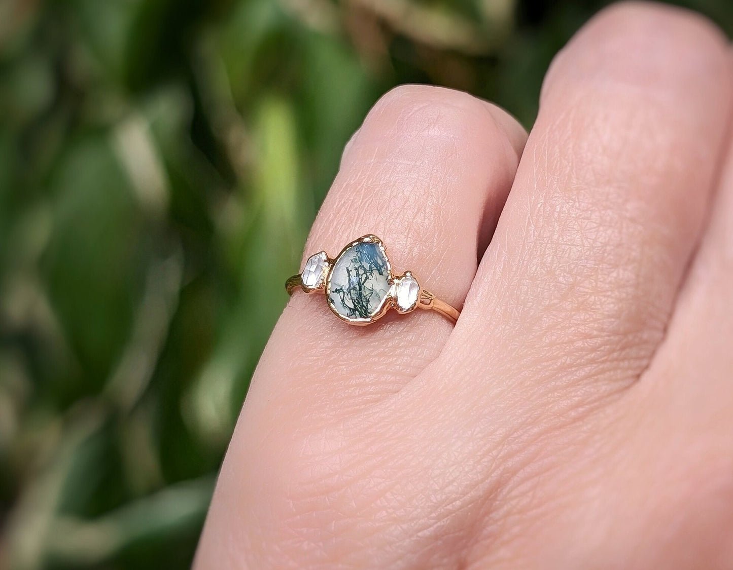 Moss Agate pear-shaped engagement ring set on a 14k gold band with Herkimer diamonds.