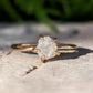 Raw diamond engagement ring in gold setting, showcasing its unique, uncut diamond design.