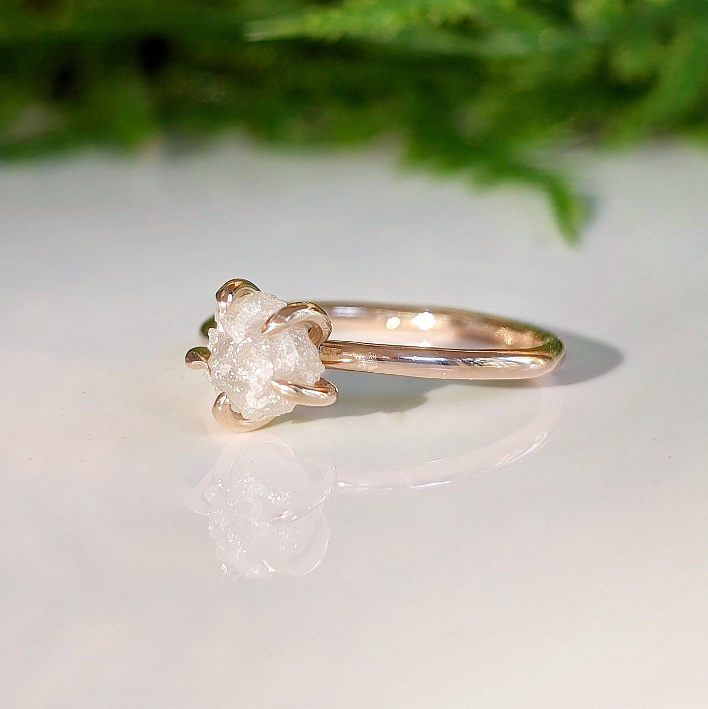 Raw diamond engagement ring in recycled gold showcasing unique, uncut diamond design with natural beauty.